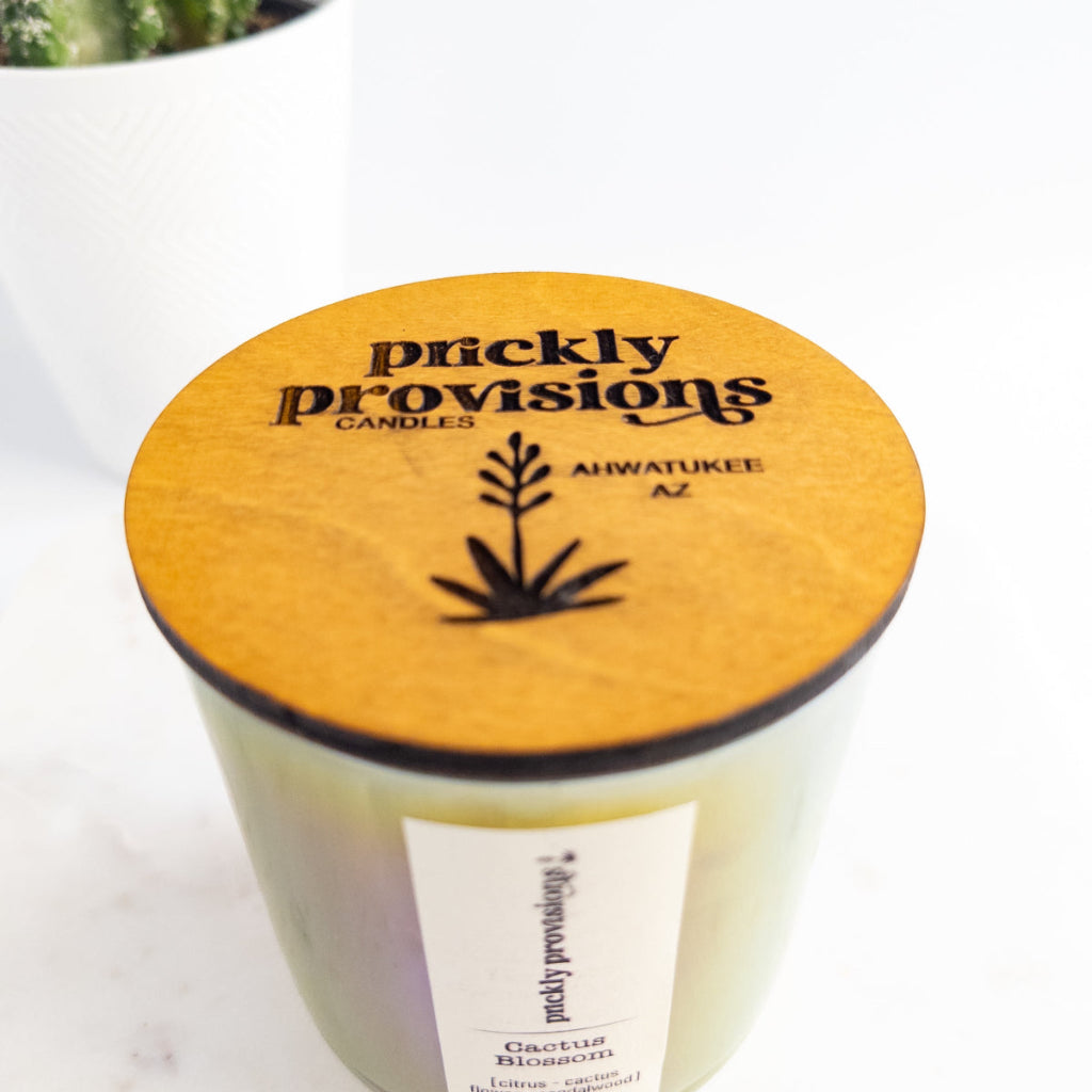Cactus Blossom 12 oz wood-wick candle in an iridescent sage glass vessel with coordinating lid.