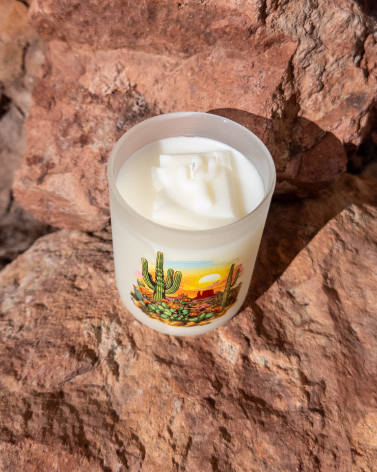 Desert Sun coconut soy candle in a printed frosted glass vessel with a glowing Arizona sunset design.