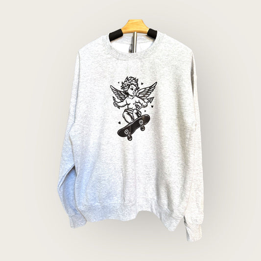 Heather gray sweatshirt with a graphic design of a cherub on a skateboard on a hanger against a light gray background.