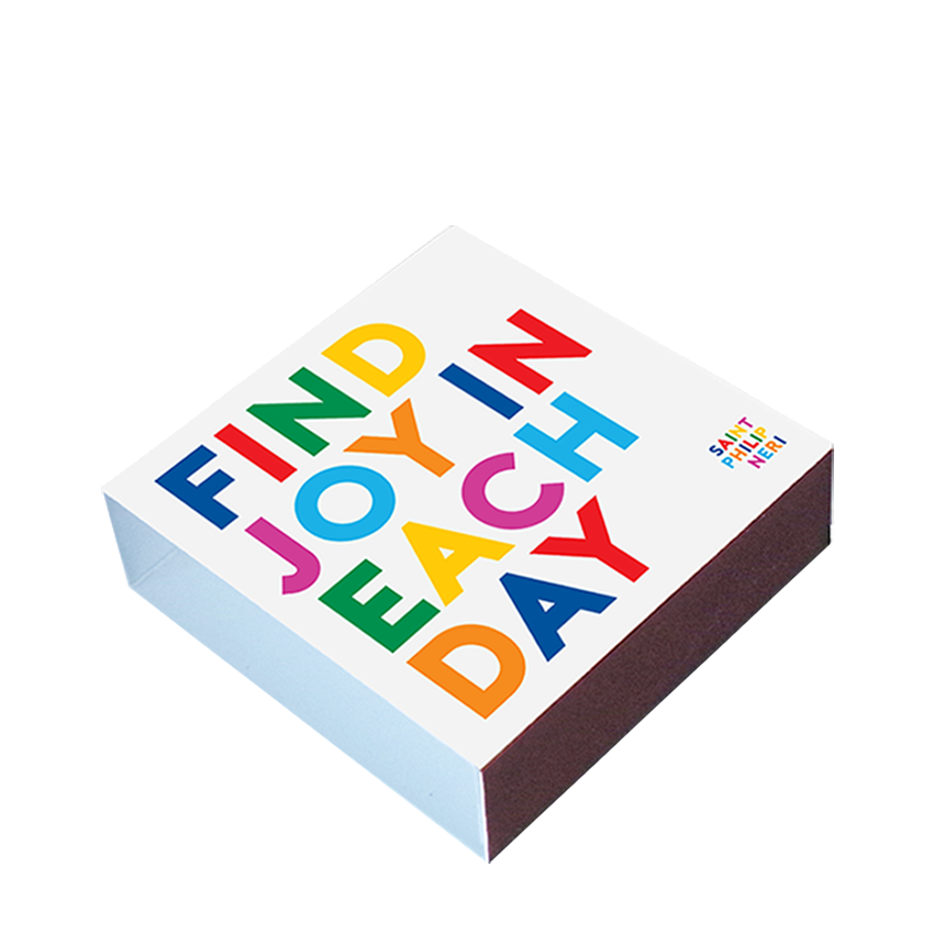 White Find Joy in Each Day matchbox with bold multicolored lettering