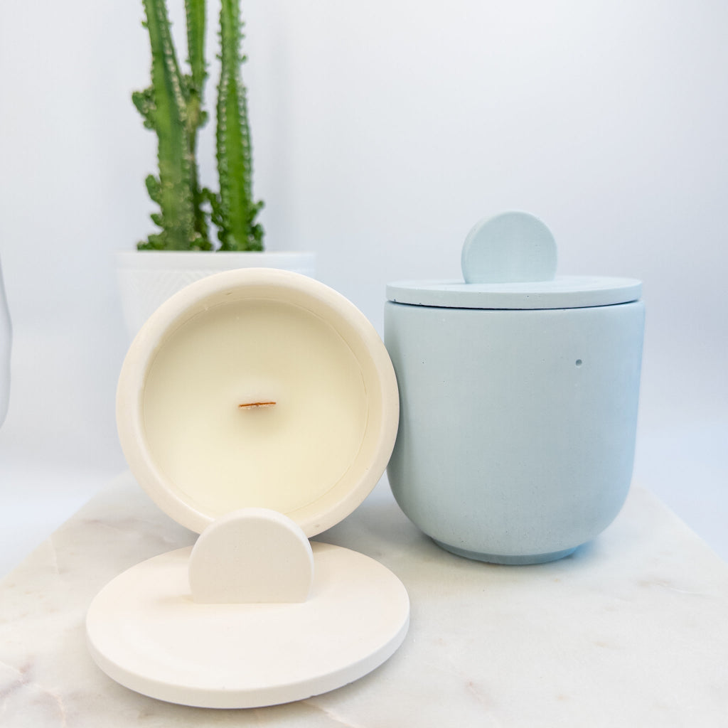 Creamy white and robin blue 8 oz cement candles with matching lid and wooden wick.