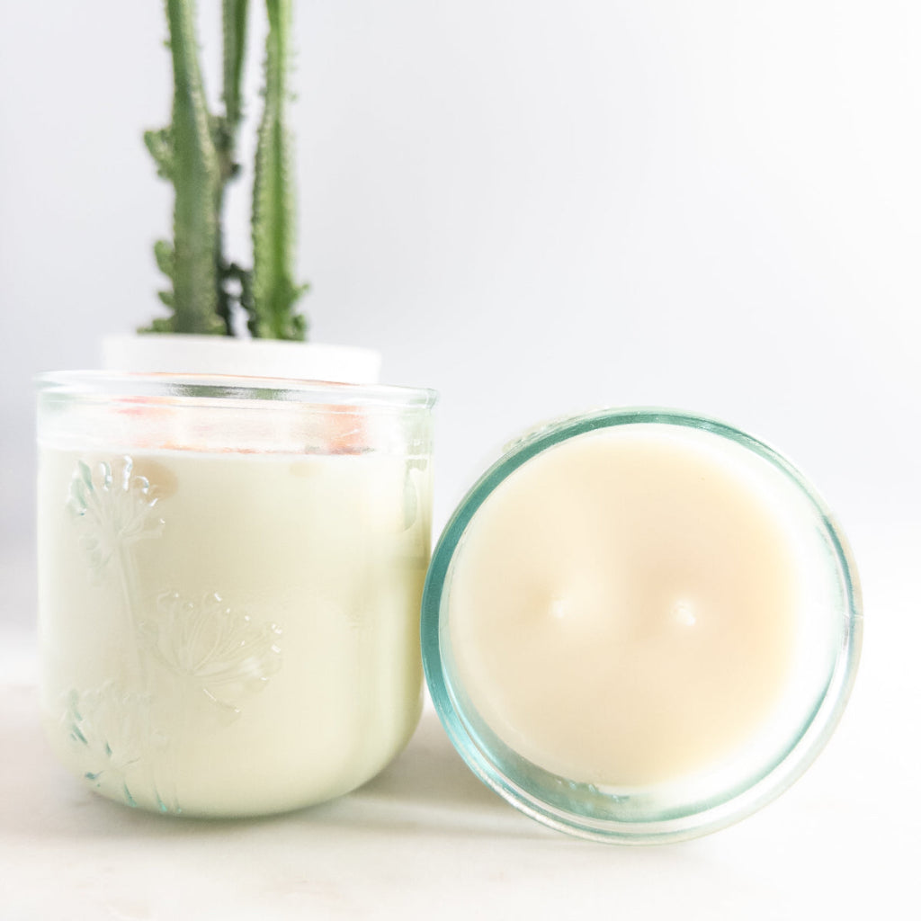 Flower Shoppe 10 oz double-wick candle in an embossed recycled-glass vessel with a floral label.
