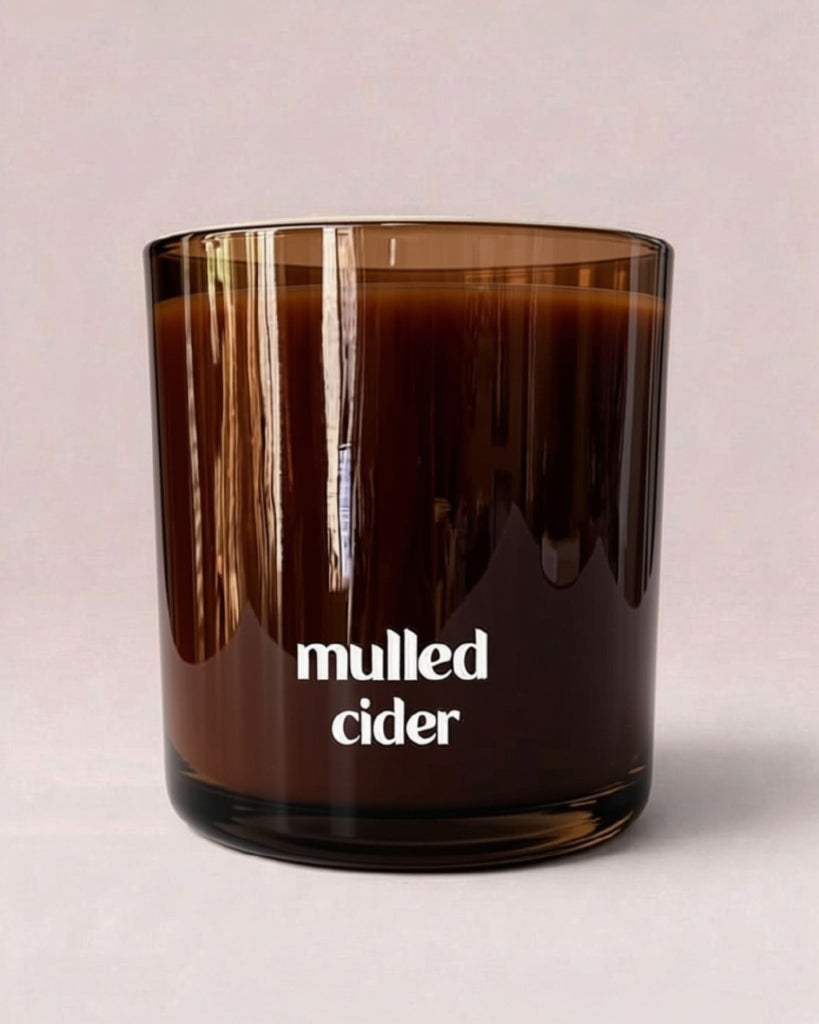 Mulled Cider 9 oz double-wick candle in translucent amber glass with wooden lid