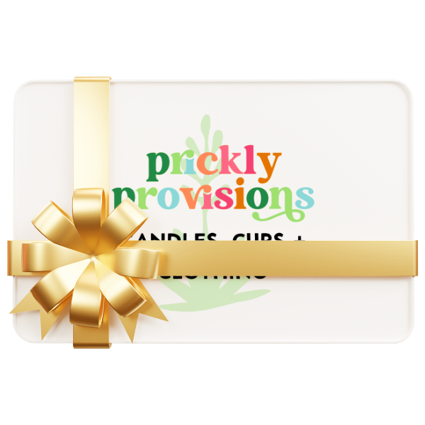 Logo of Prickly Provisions with colorful text and an agave plant design on a white gift card wrapped with a gold bow.