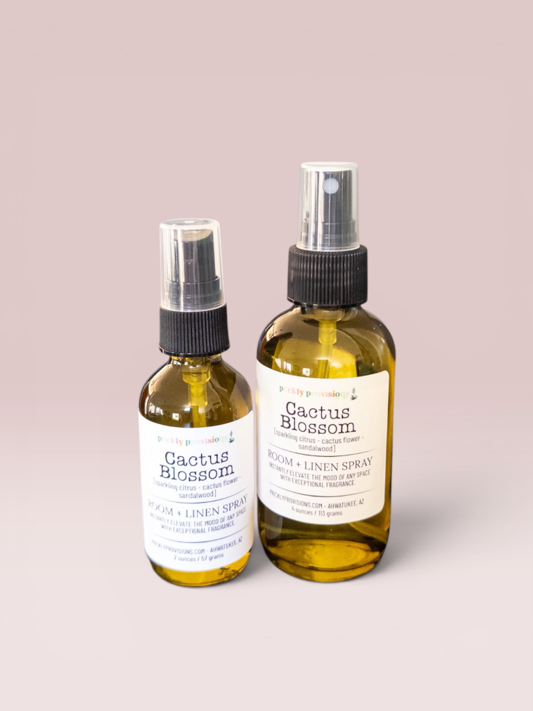 Cactus Blossom 2 oz and 4 oz room and linen spray in a transparent green bottle with a black sprayer.