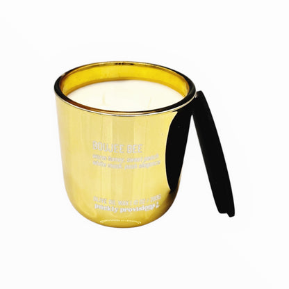 Gold mirror candle with two wicks on a white background