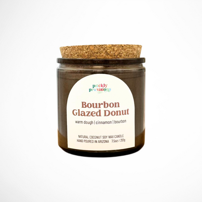 Candle jar with cork lid and 'Prickly Provisions' label on a white background