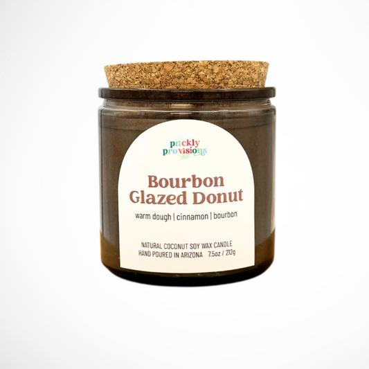 Candle jar with cork lid and 'Prickly Provisions' label on a white background