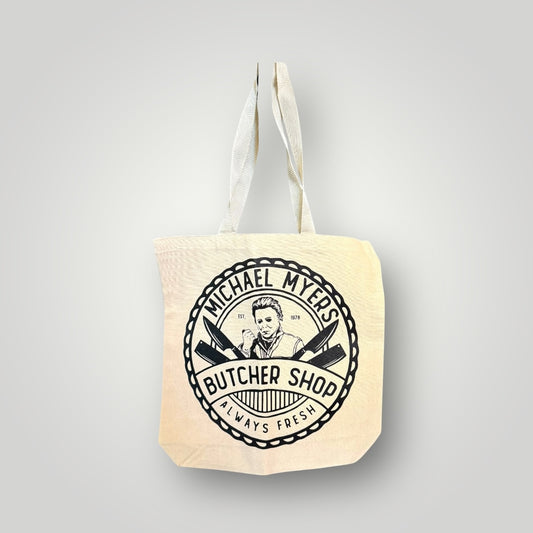 Tote bag with 'Michael Myers Butcher Shop' design on a gray background