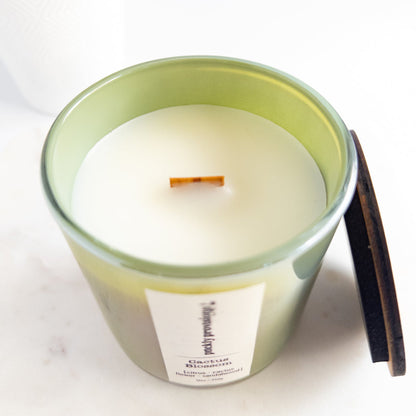 Cactus Blossom 12 oz wood-wick candle in an iridescent sage glass vessel with coordinating lid.