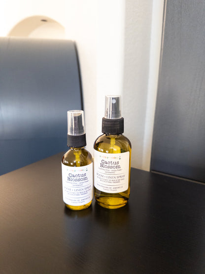 Cactus Blossom 2 oz and 4 oz room and linen spray in a transparent green bottle with a black sprayer.