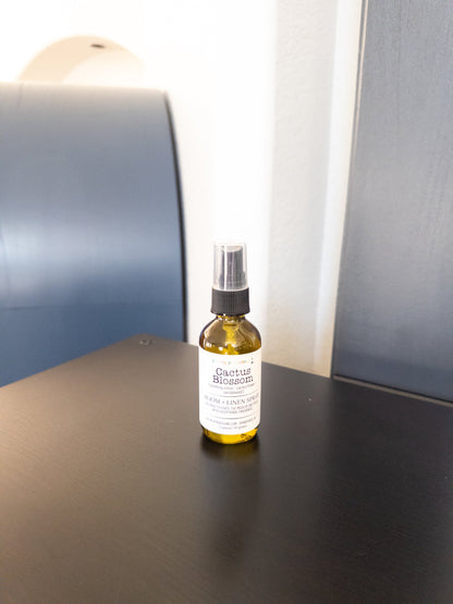 Cactus Blossom 2 oz room and linen spray in a transparent green bottle with a black sprayer.