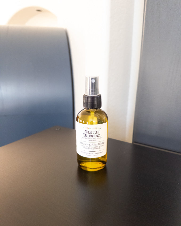 Cactus Blossom 4 oz room and linen spray in a transparent green bottle with a black sprayer.