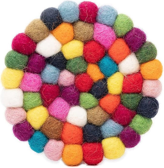 Multicolored felt ball coaster on a white background