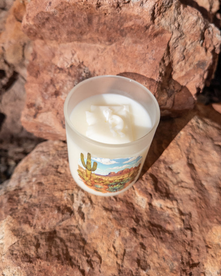 Desert Rain coconut soy candle in a printed frosted glass vessel with an Arizona desert landscape.
