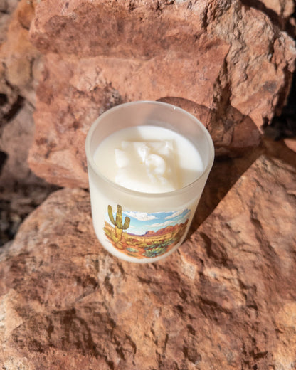 Desert Rain coconut soy candle in a printed frosted glass vessel with an Arizona desert landscape.