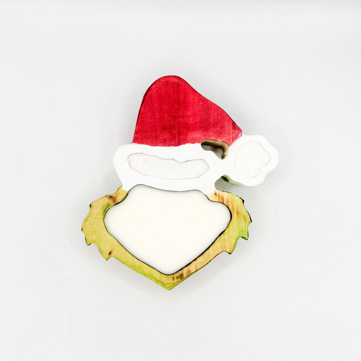 A Grinch head shaped wooden dough bowl candle with 3 wicks