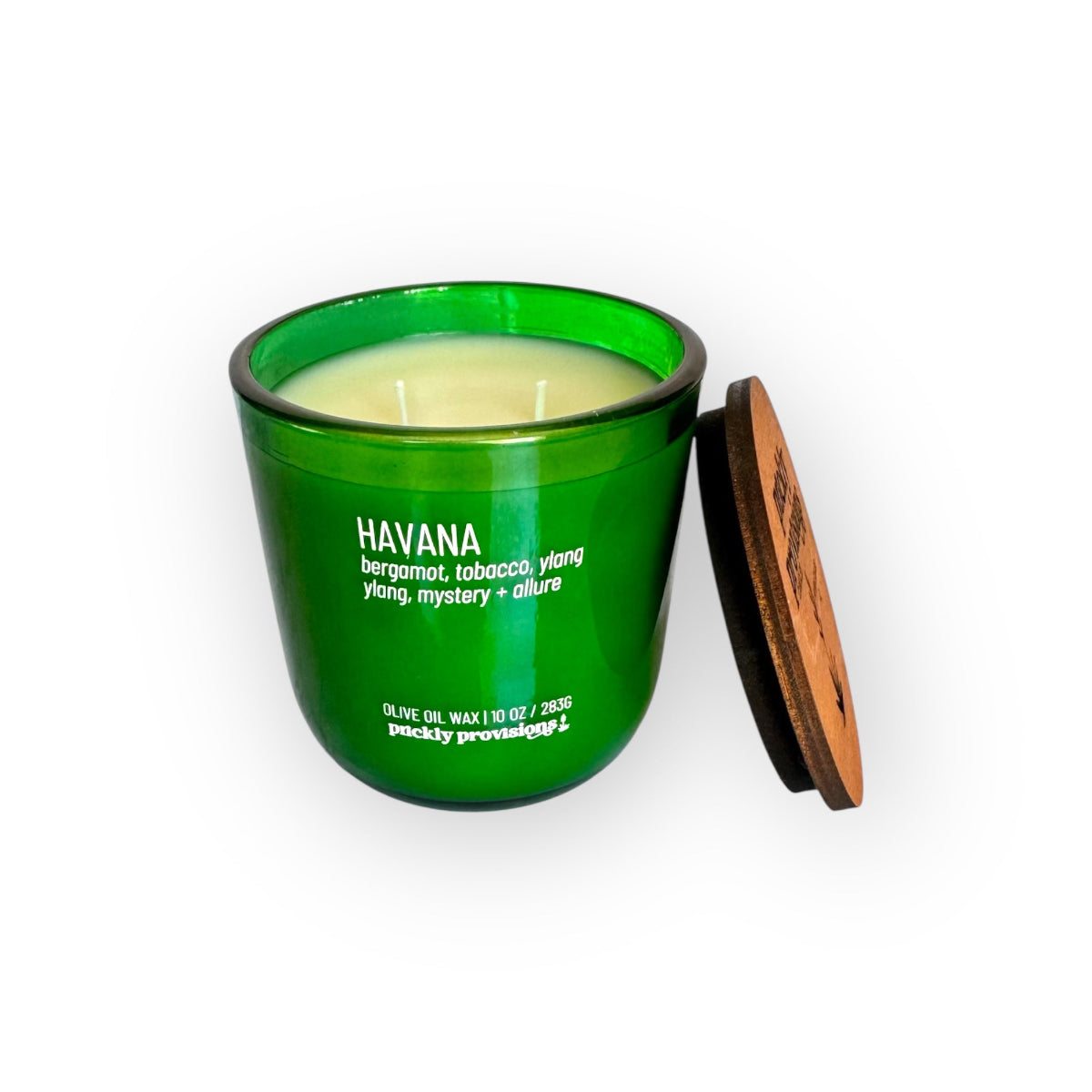 Green candle jar with wooden lid on a white background