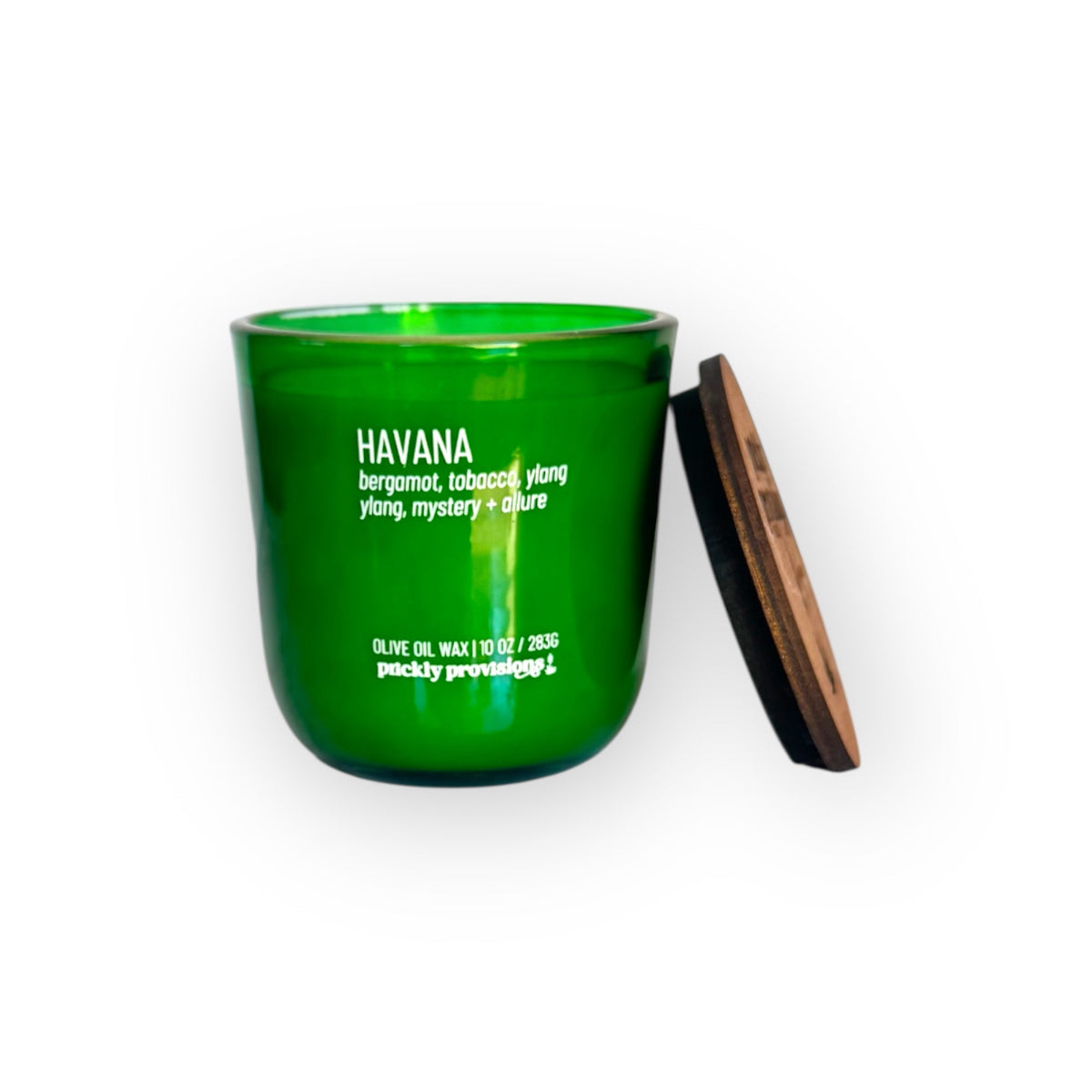 Green candle jar with wooden lid on a white background