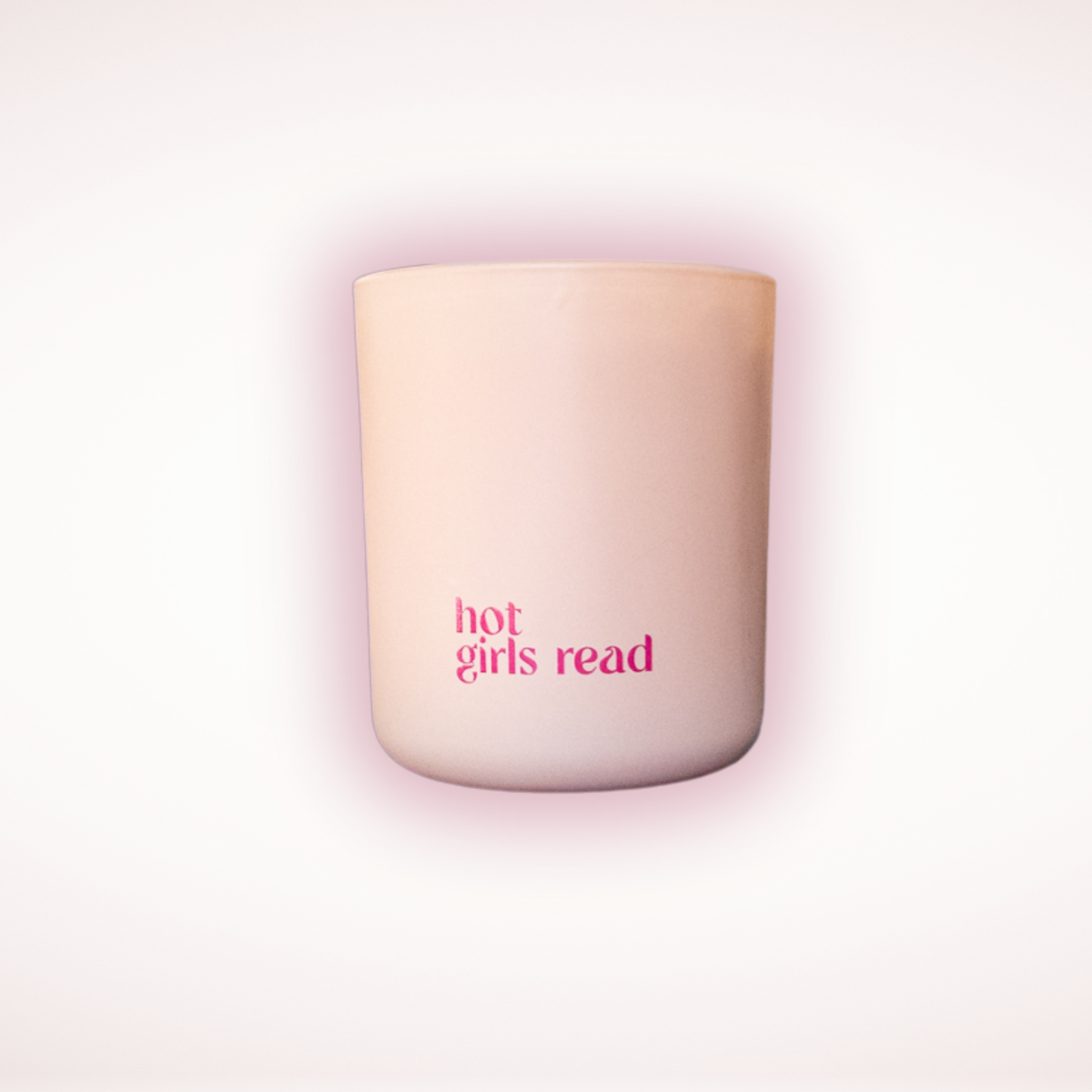 Blush candle with 'hot girls read' text on a light pink background