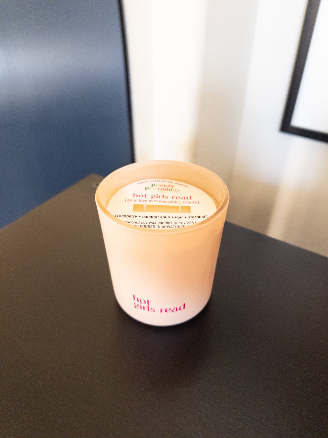 Candle with a label on a dark surface