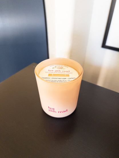 Candle with a label on a dark surface