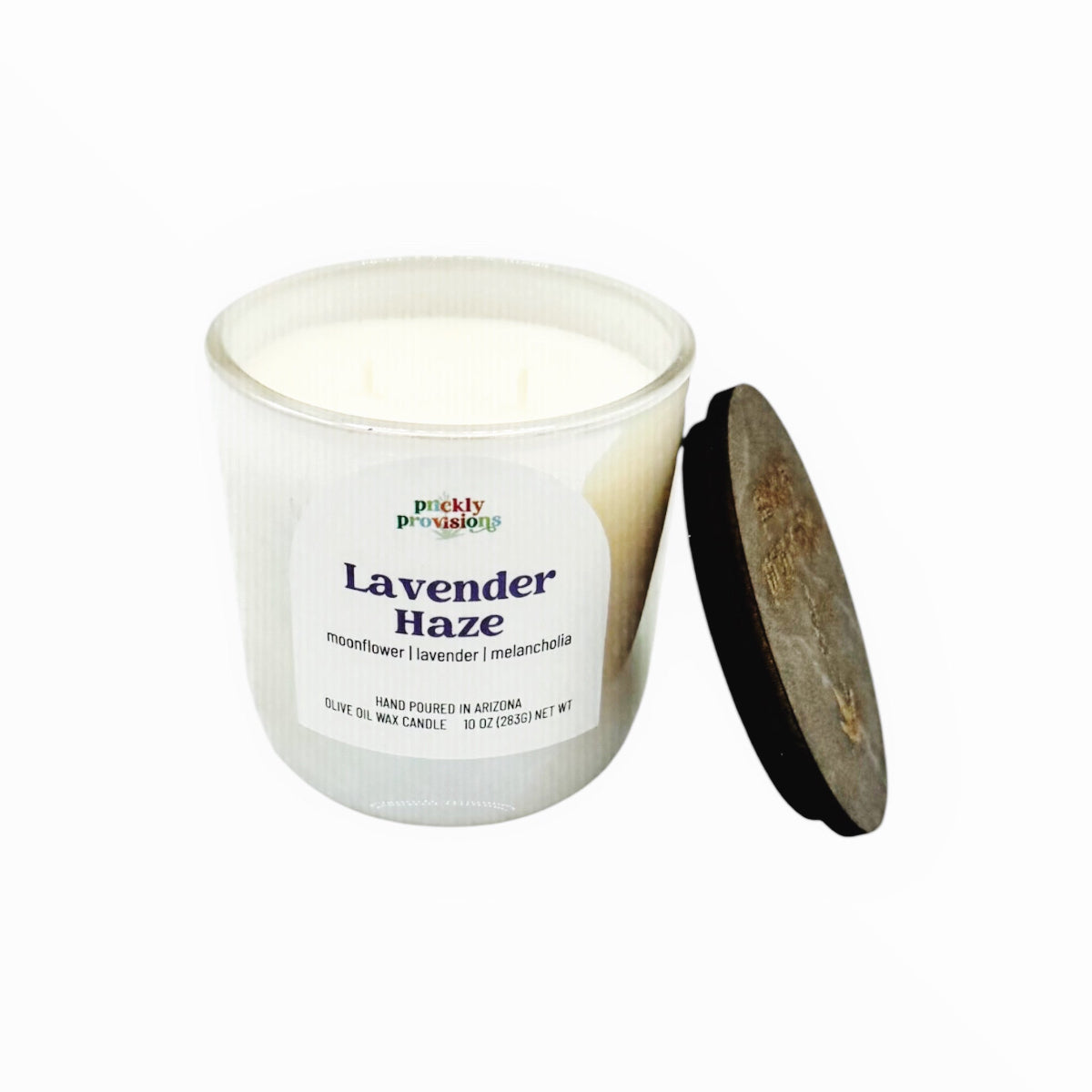 Candle with a label leading lavender haze on a white background