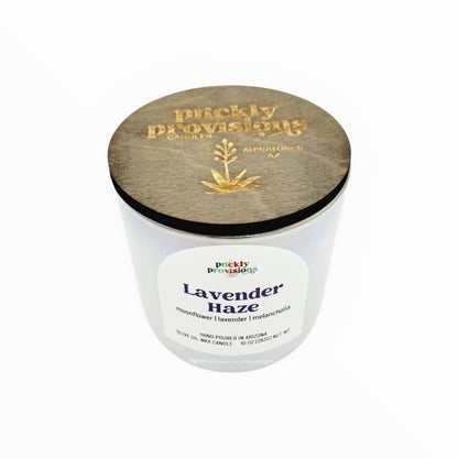 Candle with wooden lid labeled 'Lavender Haze' by 'Pruckly Provisions'.