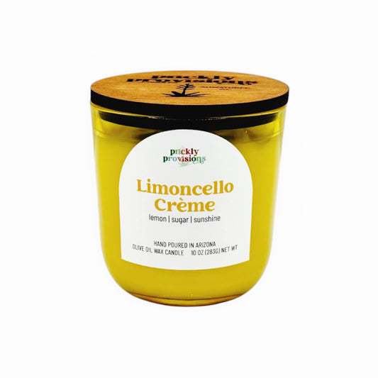 Yellow candle with a wooden lid labeled 'Limoncello Crème' on a white background
