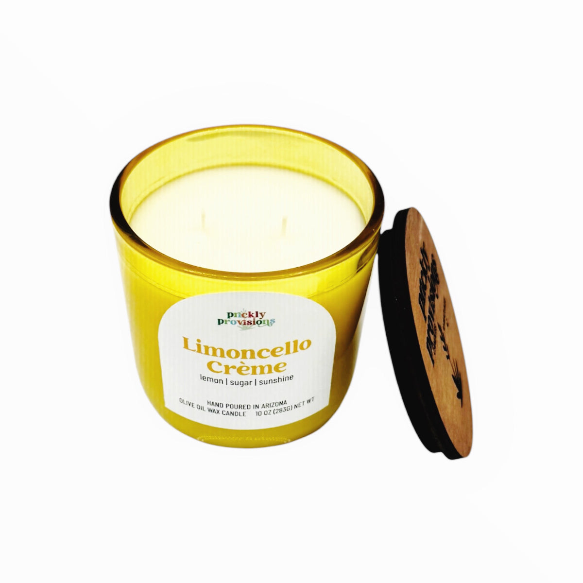 Yellow candle labeled 'Limoncello Crème' with a wooden lid on a white background