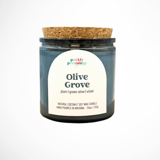 Candle jar labeled 'Olive Grove' by Prickly Provisions on a white background