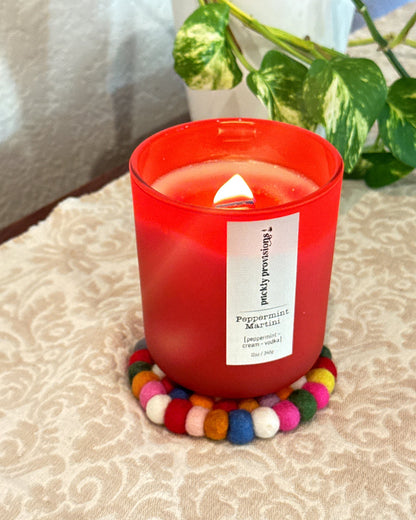 Prickly Provisions candle displayed on a multicolored felted wool coaster