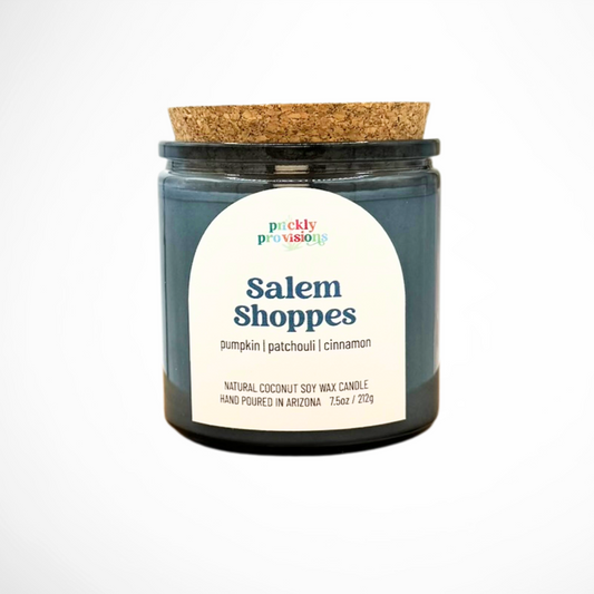 Candle jar with a cork lid and 'Salem Shoppes' label on a white background