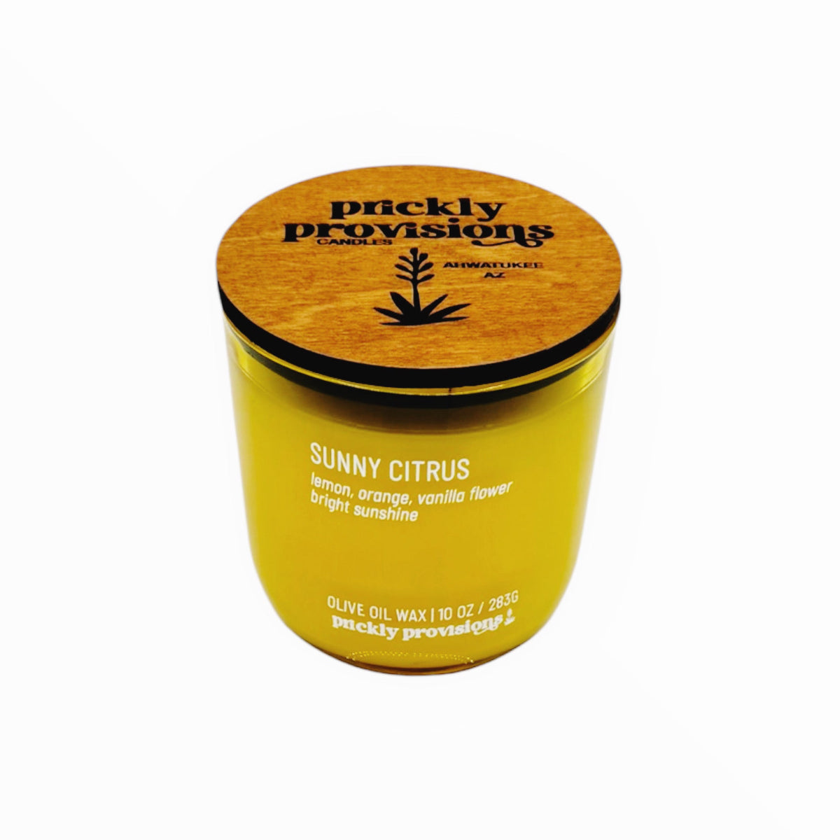 Yellow candle with wooden lid labeled 'Prickly Provisions' on a white background