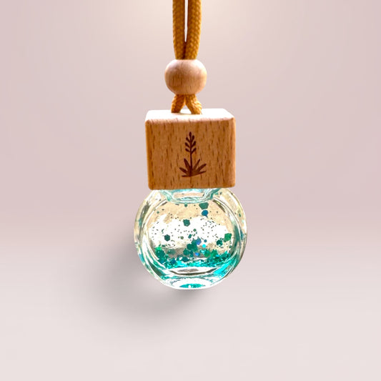 Sweet Grace 8 mL hanging car diffuser with decorative shimmer, engraved wooden lid, and hanging cord.