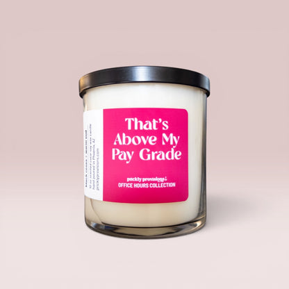 That’s Above My Pay Grade 10 oz double-wick office candle with a bright pink label and black metal lid.