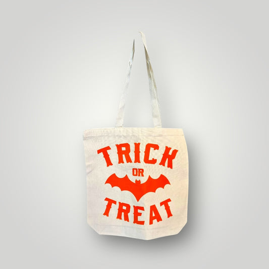 Canvas tote bag with 'Trick or Treat' text and bat design on a gray background