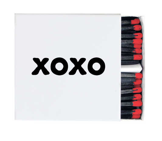 White XOXO decorative matchbox with black lettering, black matches, and red tips
