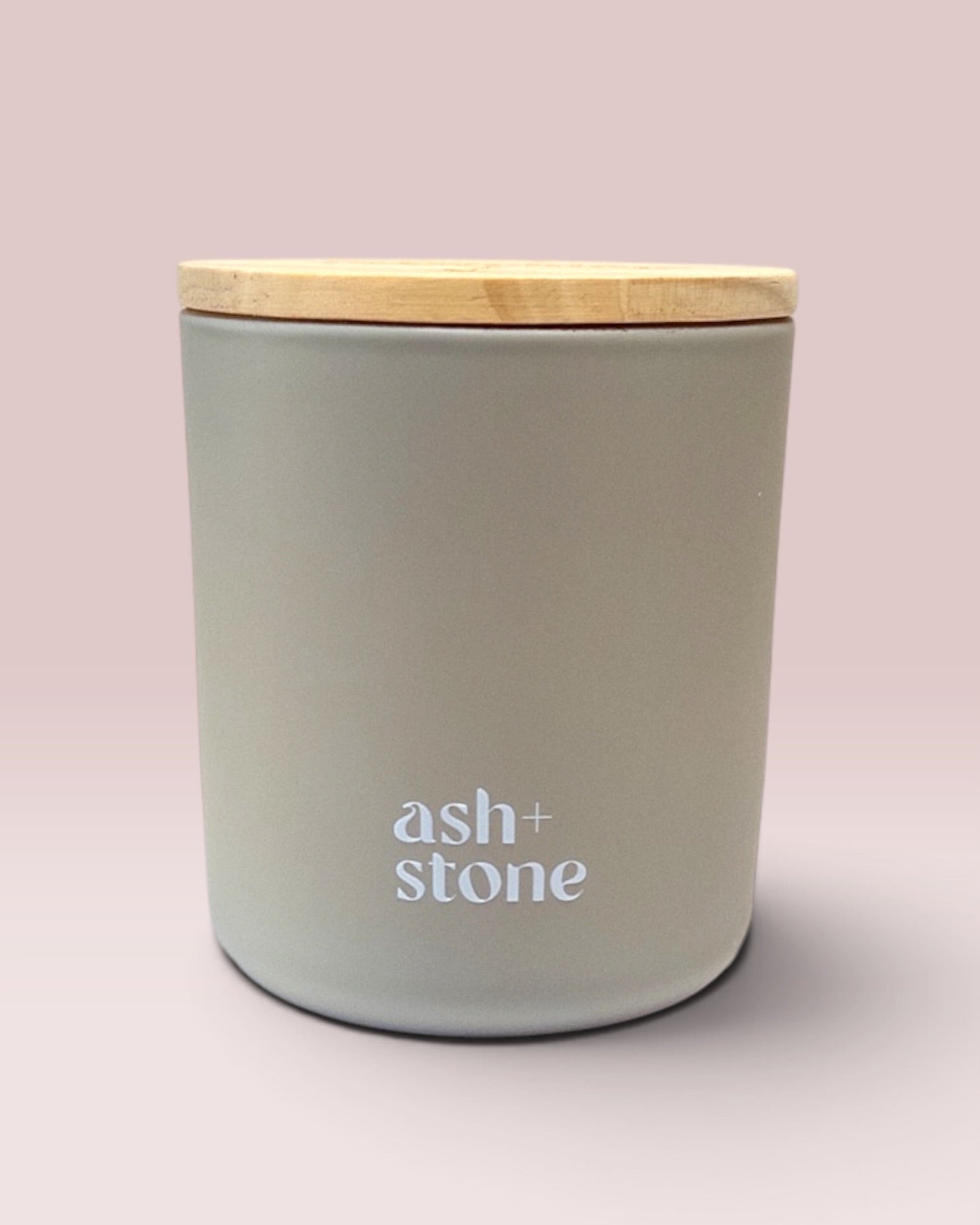 Ash + Stone 9 oz double-wick candle in a matte stone glass vessel.
