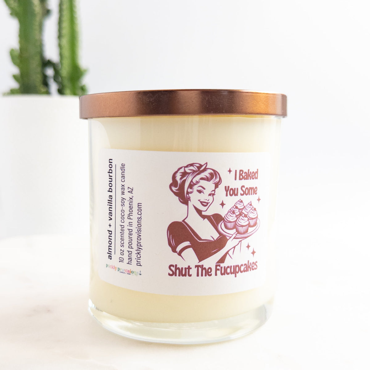 Candle with a humorous label featuring a vintage-style illustration and text.