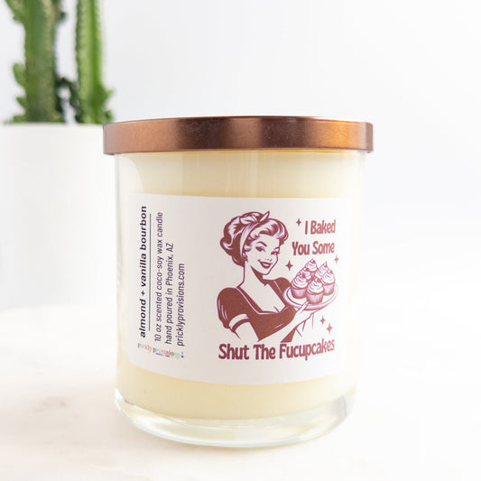 Candle with a humorous label featuring a vintage-style illustration and text.