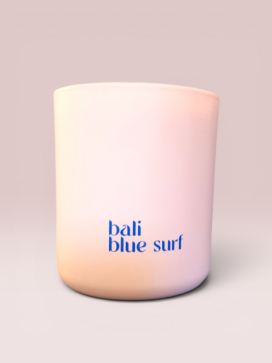 Bali Blue Surf 9 oz double-wick candle in a soft blush glass vessel.