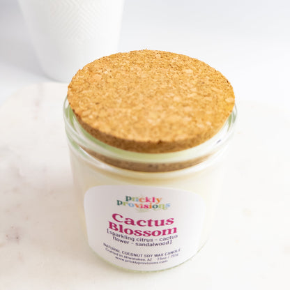 Jar of 'Cactus Blossom' candle with cork lid on a white background