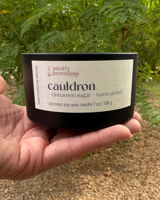 Cauldron Halloween candle in a matte black tin with 3-D printed lid