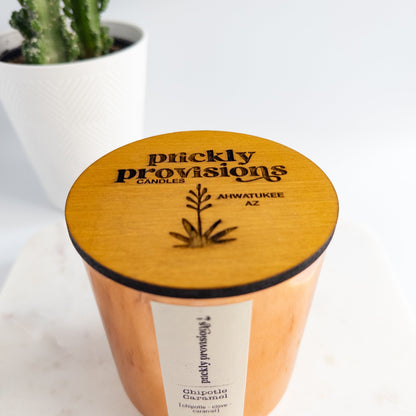 Picklely Provisions candle with wooden lid and cactus in the background