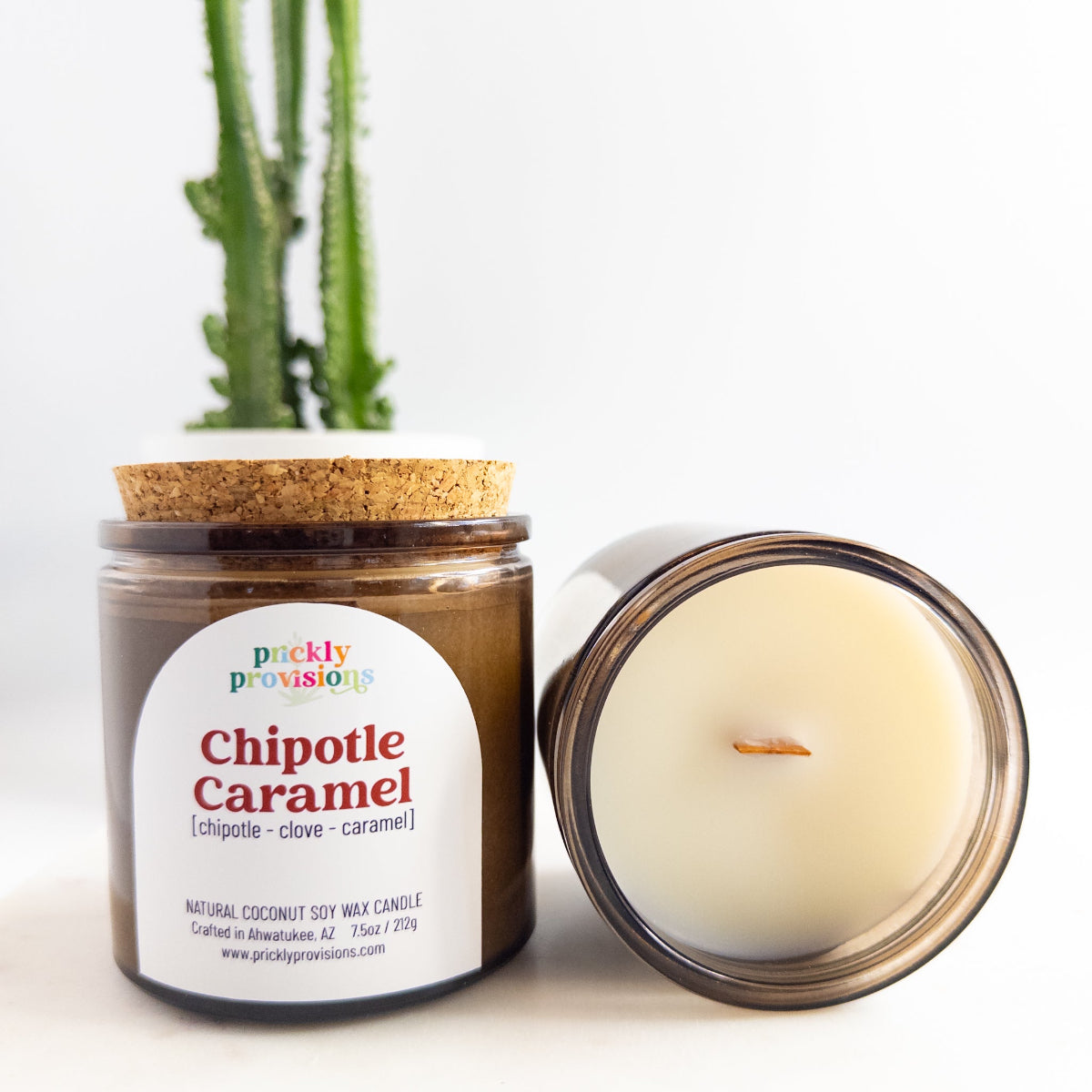 Candle jar labeled 'Chipotle Caramel' by 'prickly provisions' with a cactus in the background.