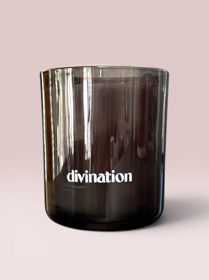 Divination 9 oz double-wick candle in a smoked black glass vessel.

