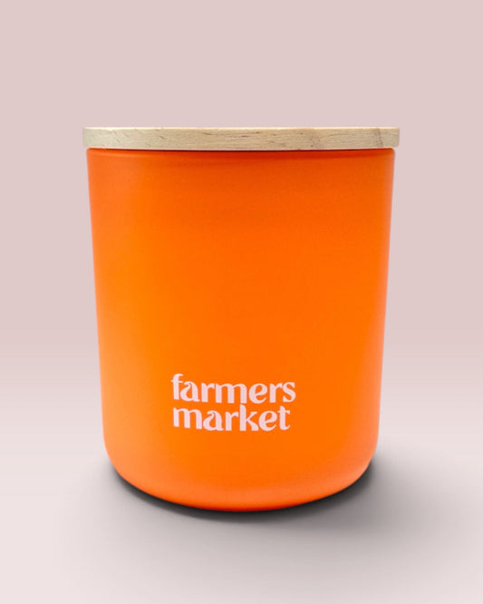 Farmers Market 12 oz wood-wick candle in matte tangerine glass with coordinating wood lid