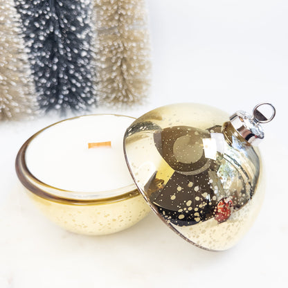 Decorative glass ornament with gold base on a white background