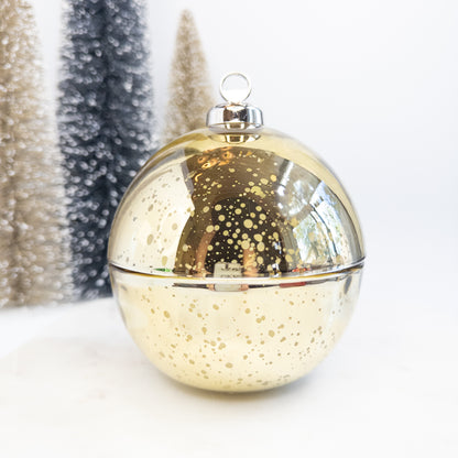 Gold Christmas ornament with silver top on a white background